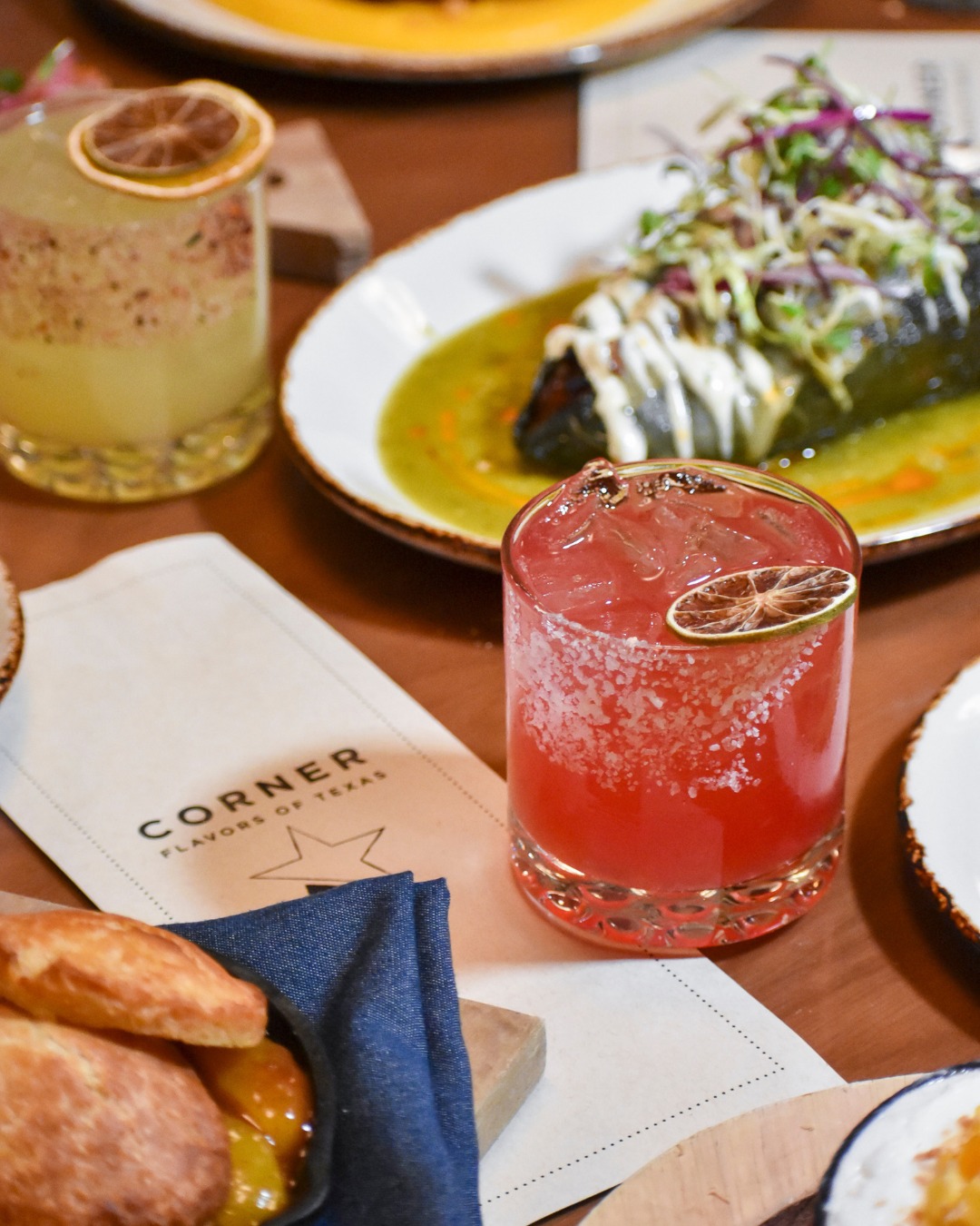 Cocktails, a chili dish, and biscuits with a "Flavors of Texas" menu.