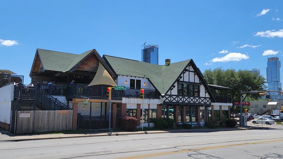 The Tavern, a Tudor-style building with patios, at Lamar Street.