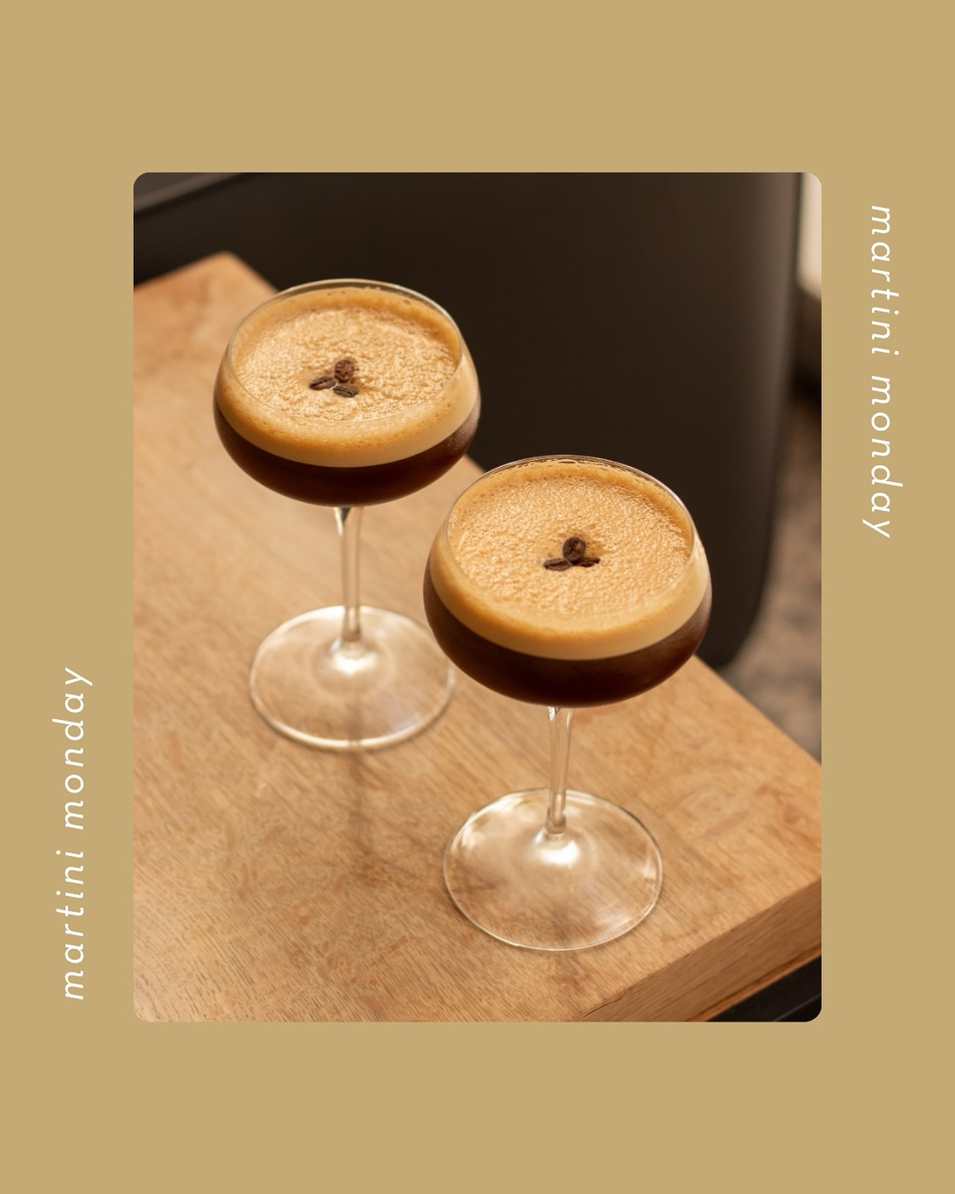 Two espresso martinis with coffee bean garnish on a wood table.