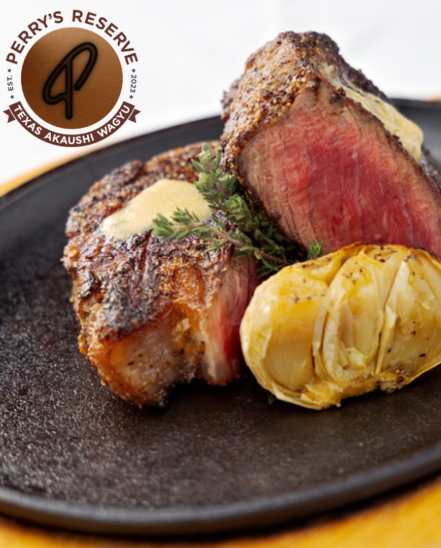 Seared medium-rare steaks with roasted garlic, butter, and thyme.