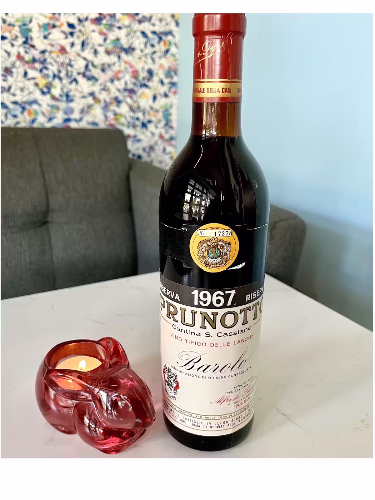 A bottle of 1967 Prunotto Barolo and a red rabbit candle holder.