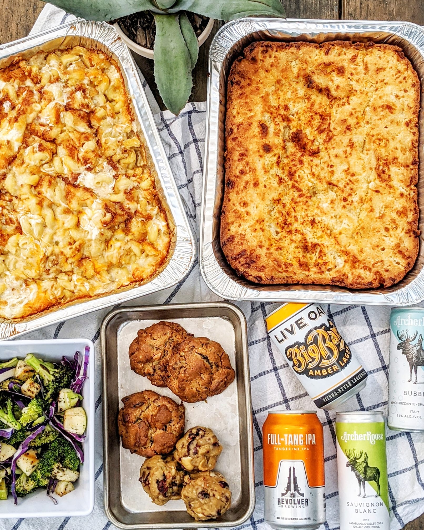 Various baked dishes, roasted vegetables, cookies, and canned drinks.