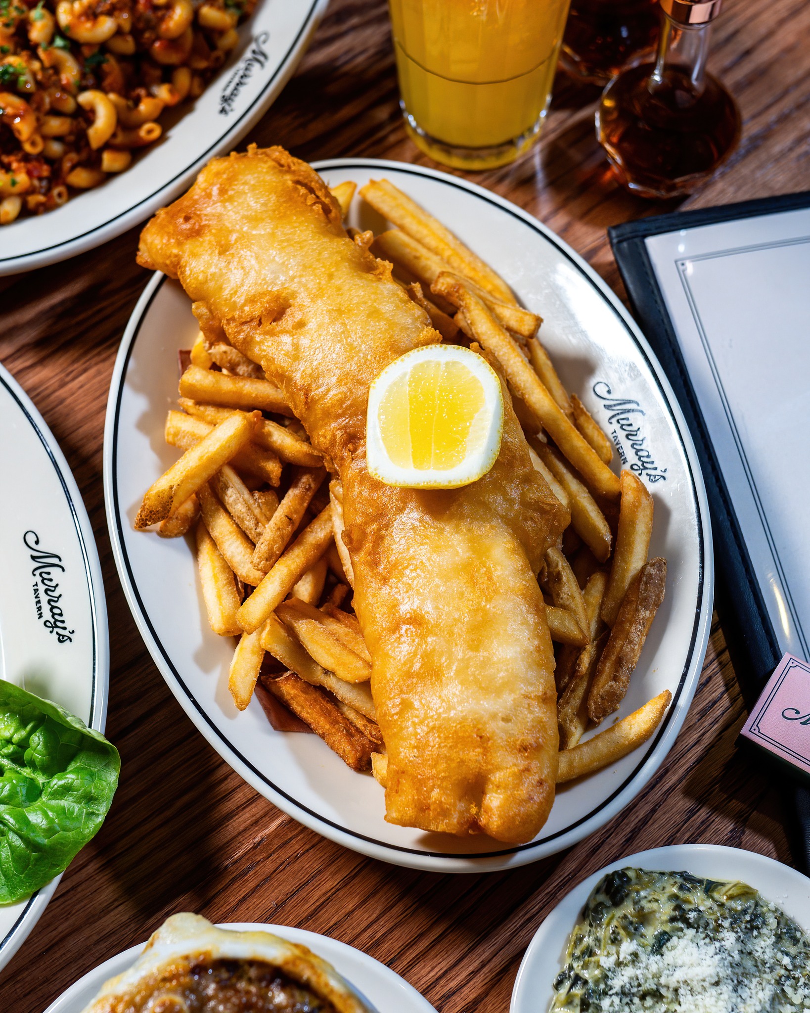 Fried fish, French fries, and lemon on a Murray's Tavern plate.