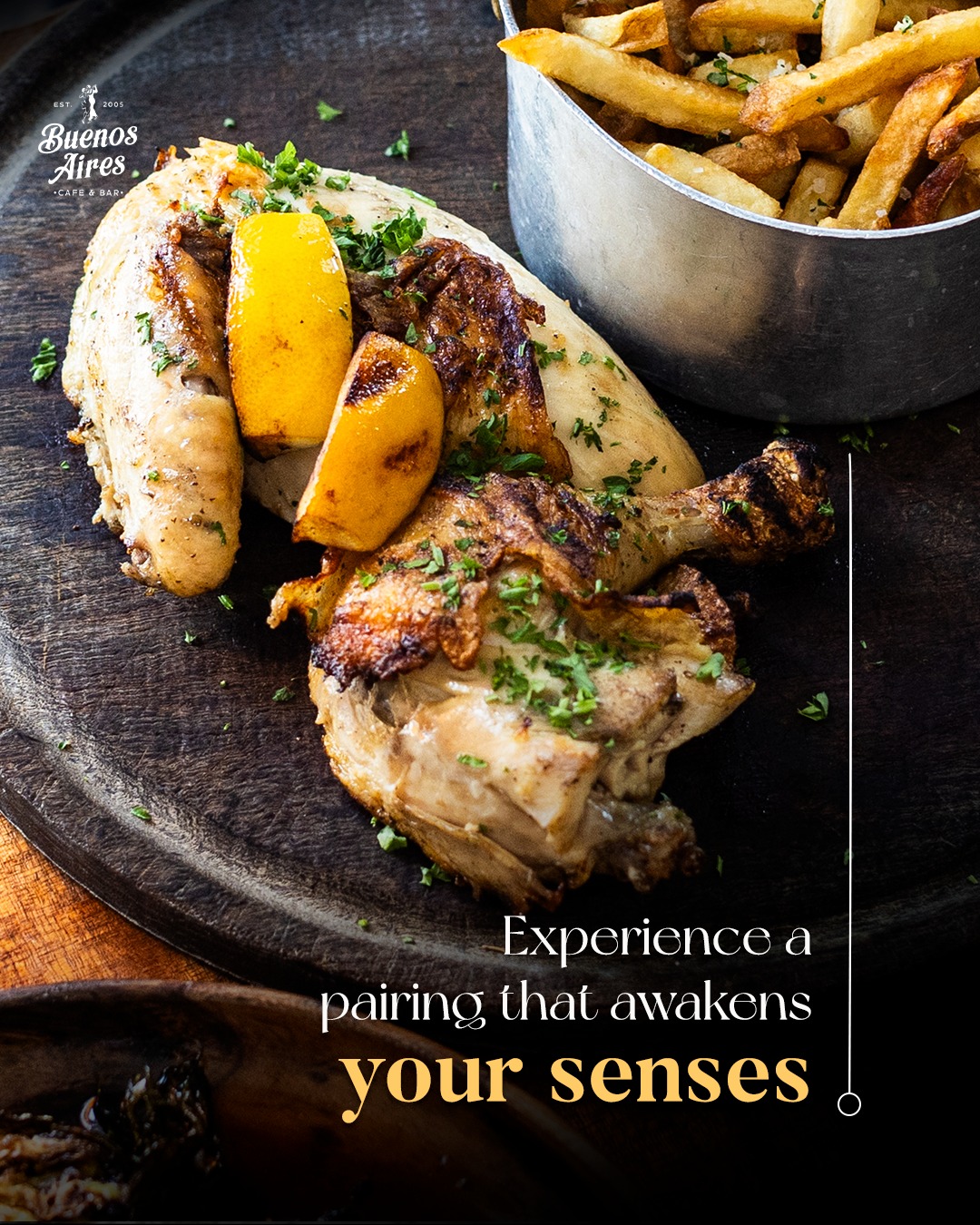 Grilled chicken with lemon, parsley, and a side of french fries.