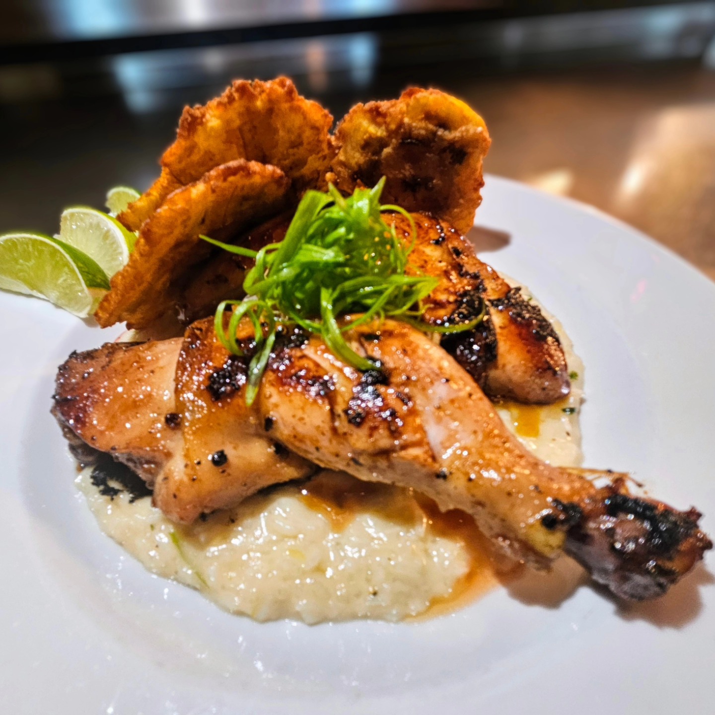 Grilled chicken, fried plantains, creamy rice, lime, and fresh herbs.