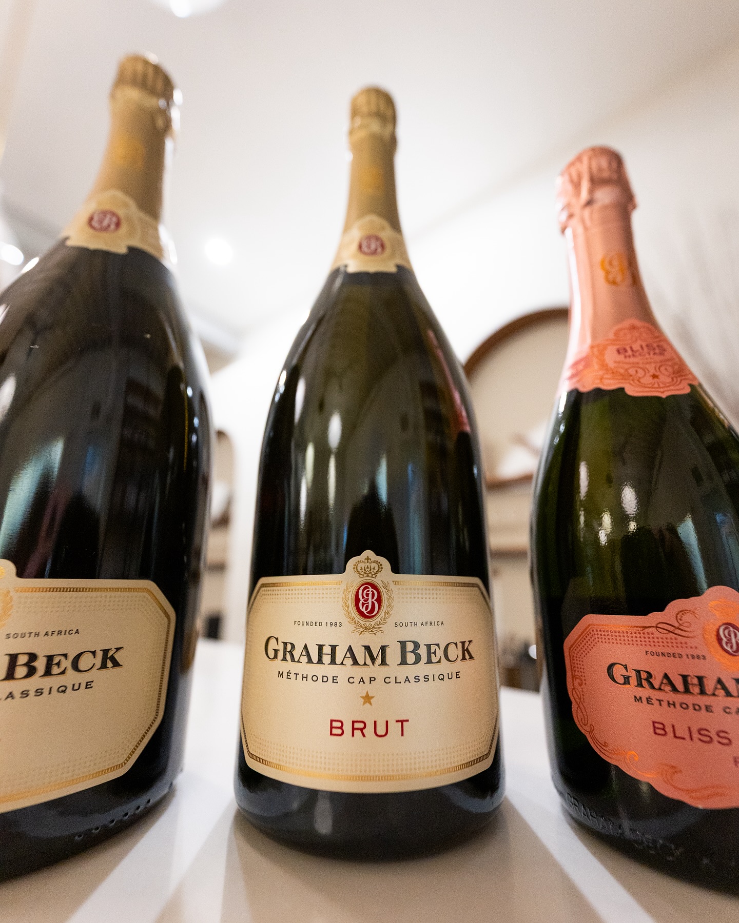 Three Graham Beck sparkling wine bottles: Brut, Classique, Bliss Nectar.
