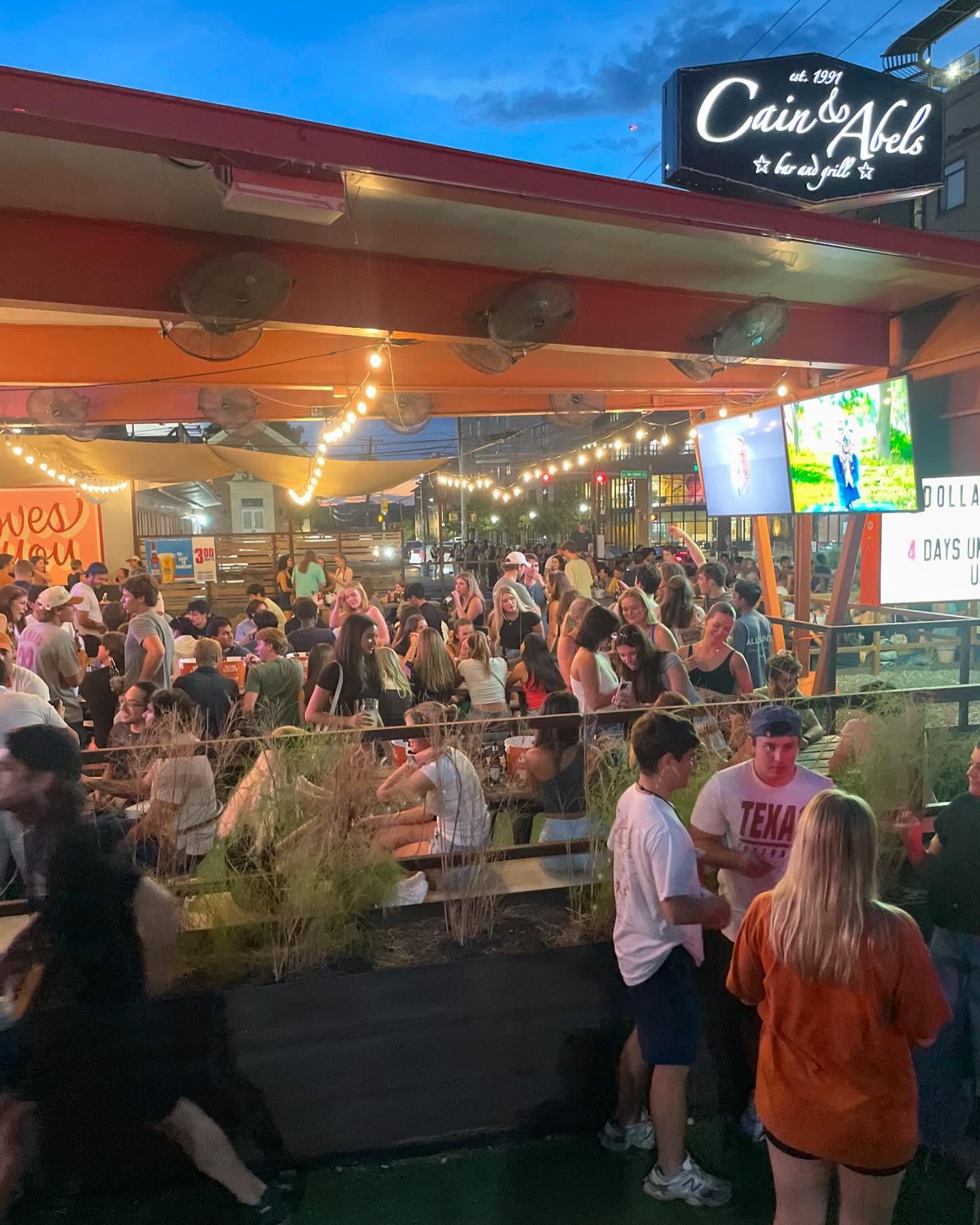 Crowded outdoor patio of Cain & Abels bar and grill.