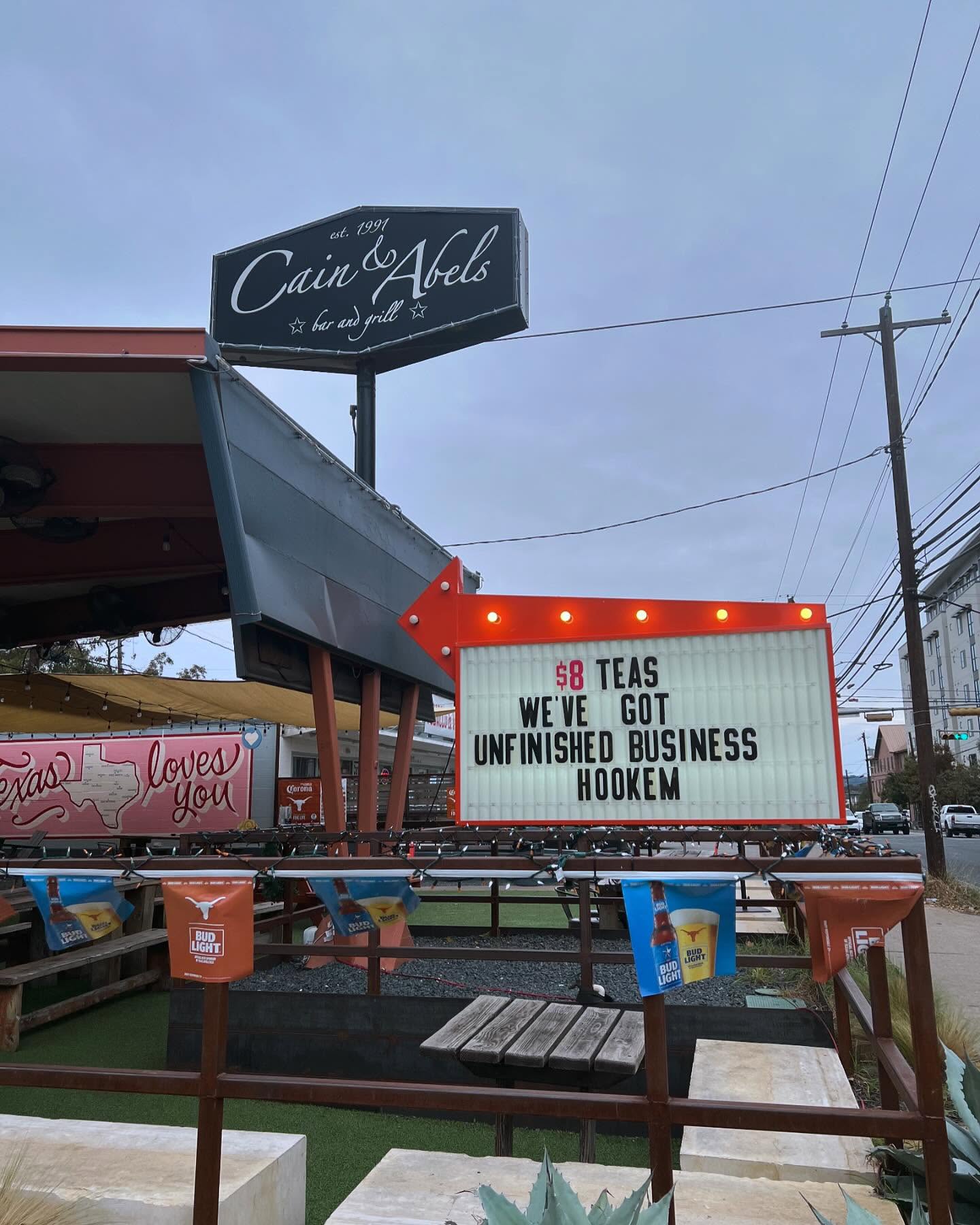 Cain & Abels bar with illuminated sign advertising "$8 TEAS HOOKEM".