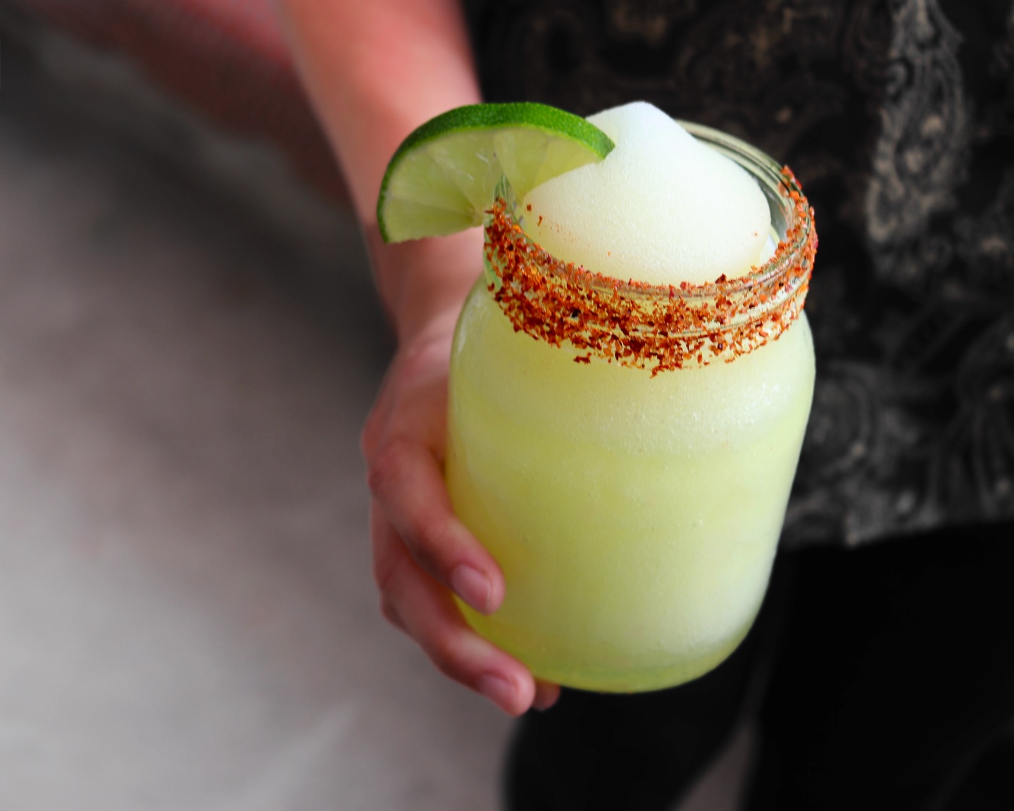 Frozen green drink with chili-spiced rim and lime.