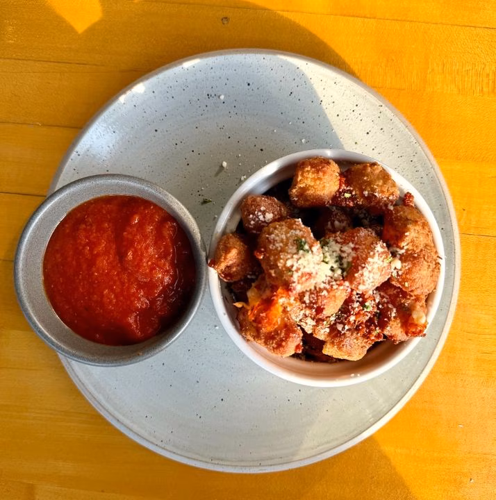 Fried cheese curds topped with parmesan, served with marinara sauce.