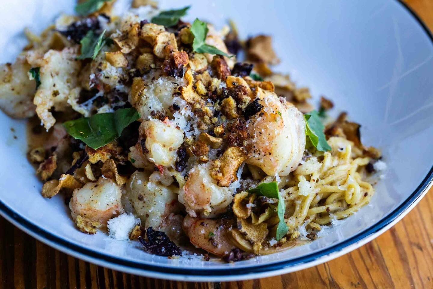 Pasta with shrimp, grated cheese, crispy crumbs, and fresh herbs.