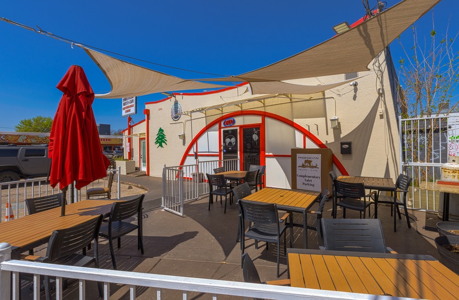 Phoenician Bistro-Cafe's outdoor patio with tables, chairs, and shade sails.
