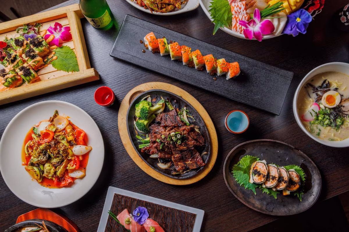 Overhead view of a table with a diverse spread of Japanese food.