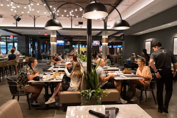 Customers and staff in a brightly lit, contemporary restaurant interior.