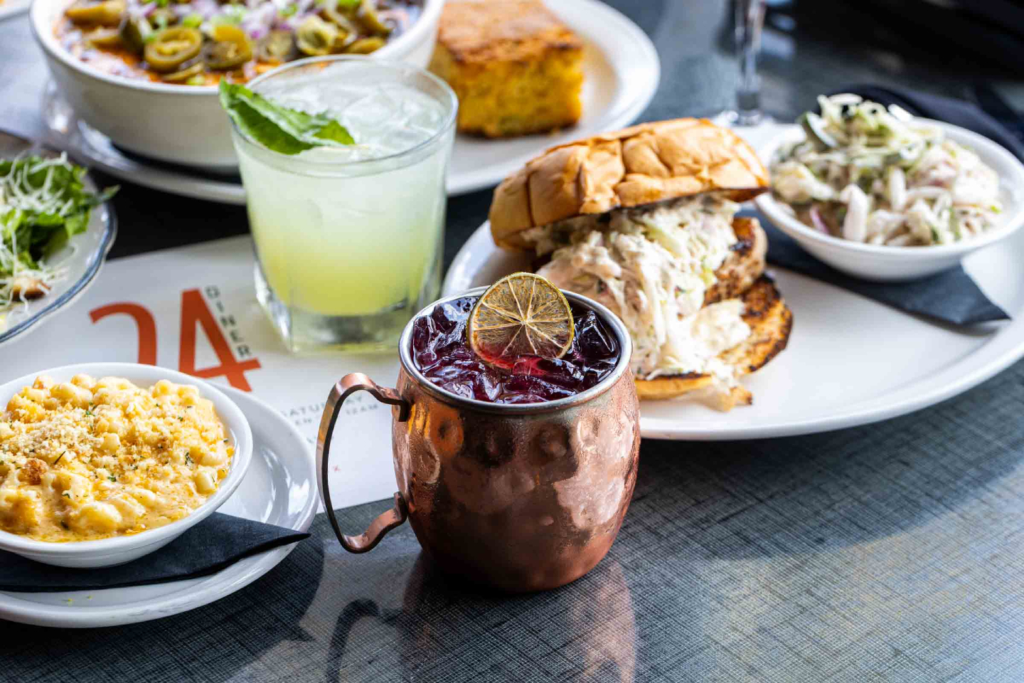 Diner food: mac and cheese, sandwich, chili, and two cocktails.