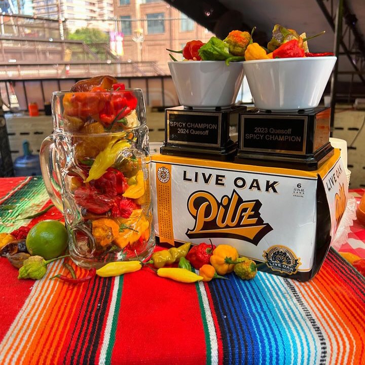 Chili peppers, two champion trophies, and a Live Oak Pilz box.