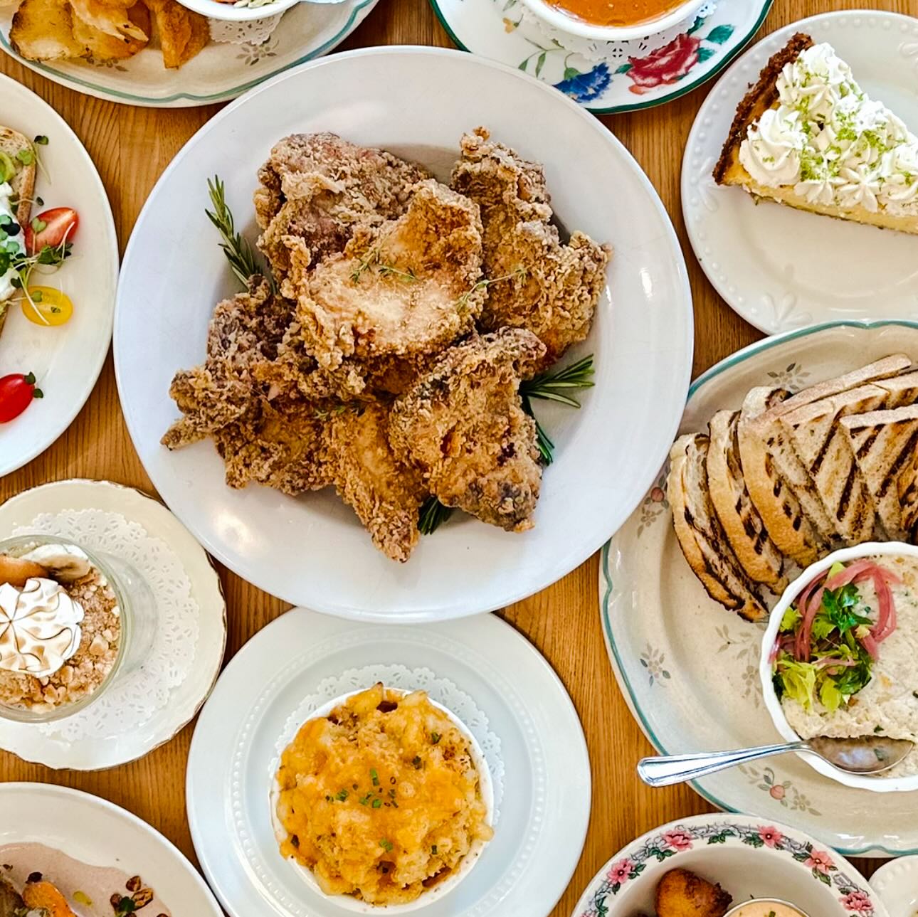 A table full of fried chicken, mac and cheese, pie, and sides.