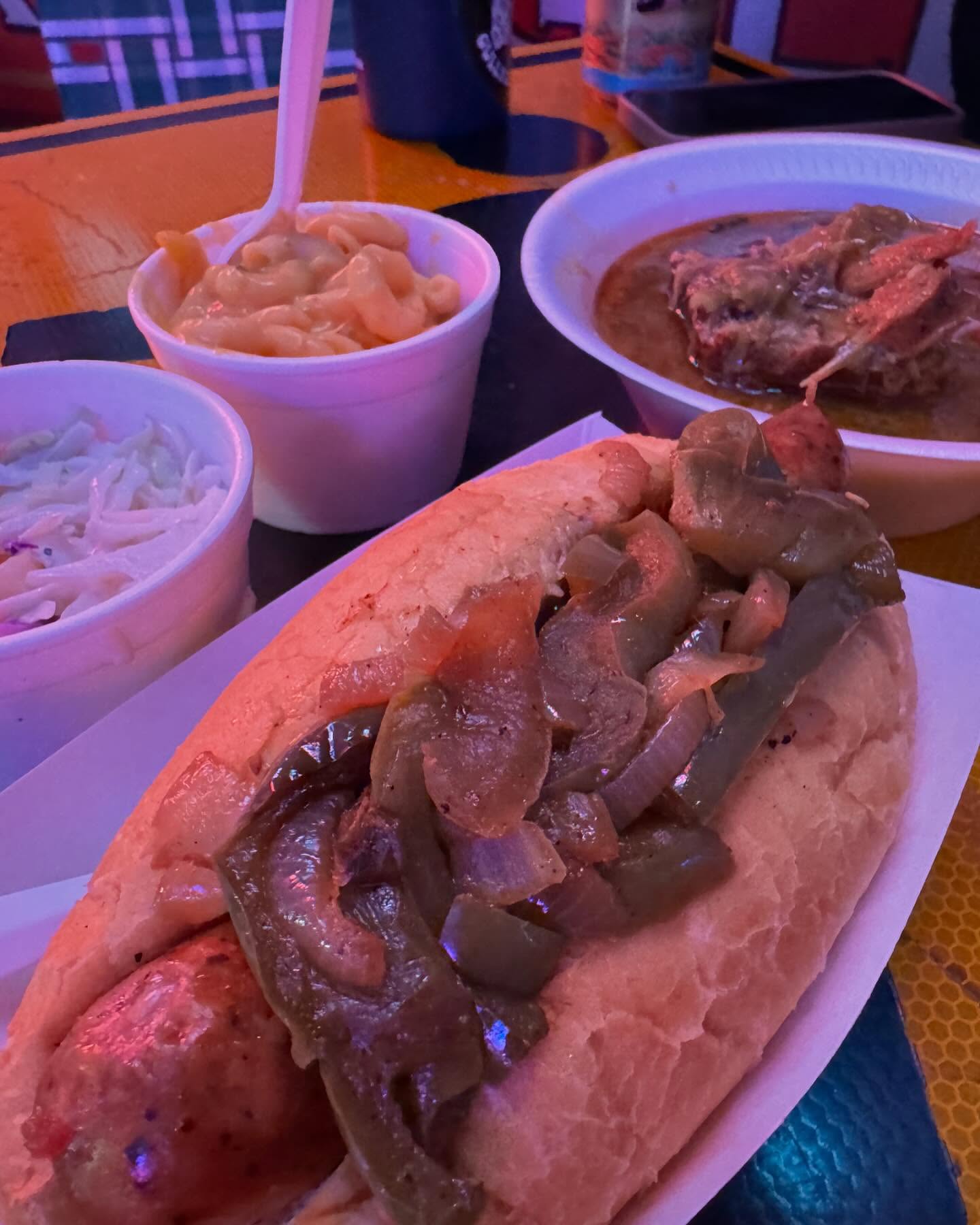 Sausage with peppers and onions, mac and cheese, stew, and coleslaw.