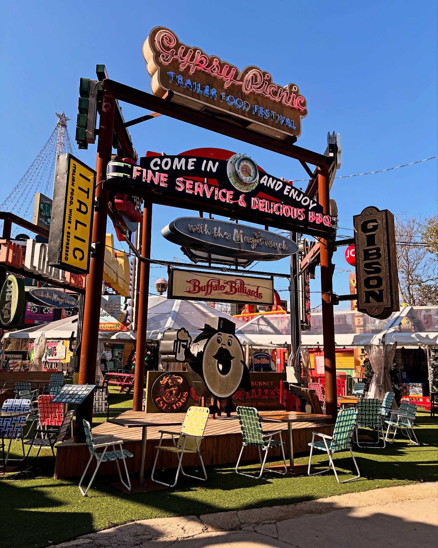 Gypsy Picnic Trailer Food Festival entrance with many neon signs.