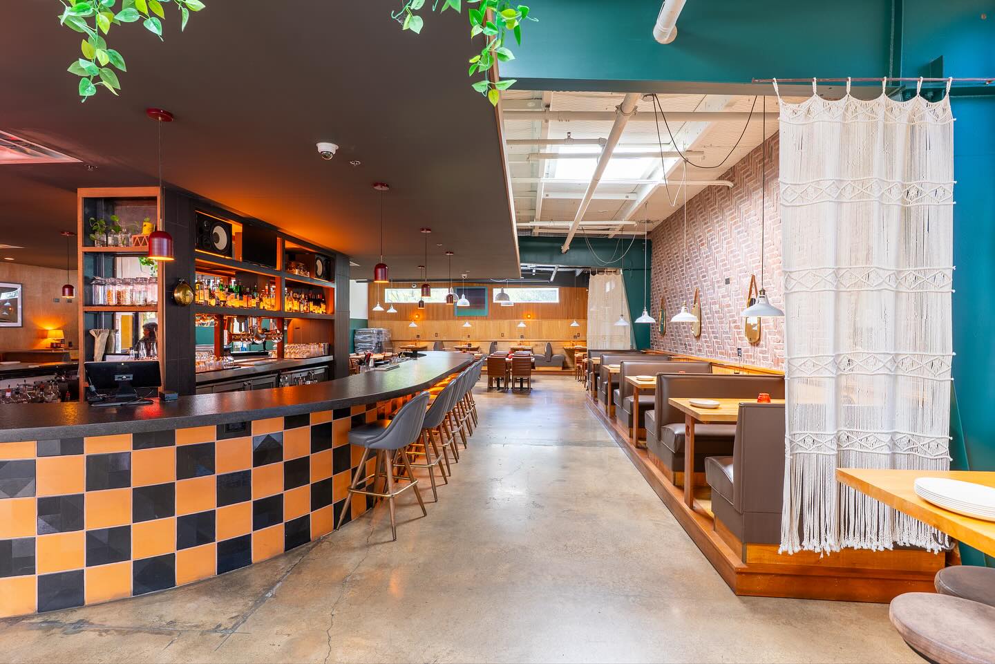 Empty bar and restaurant interior with modern design and warm lighting.