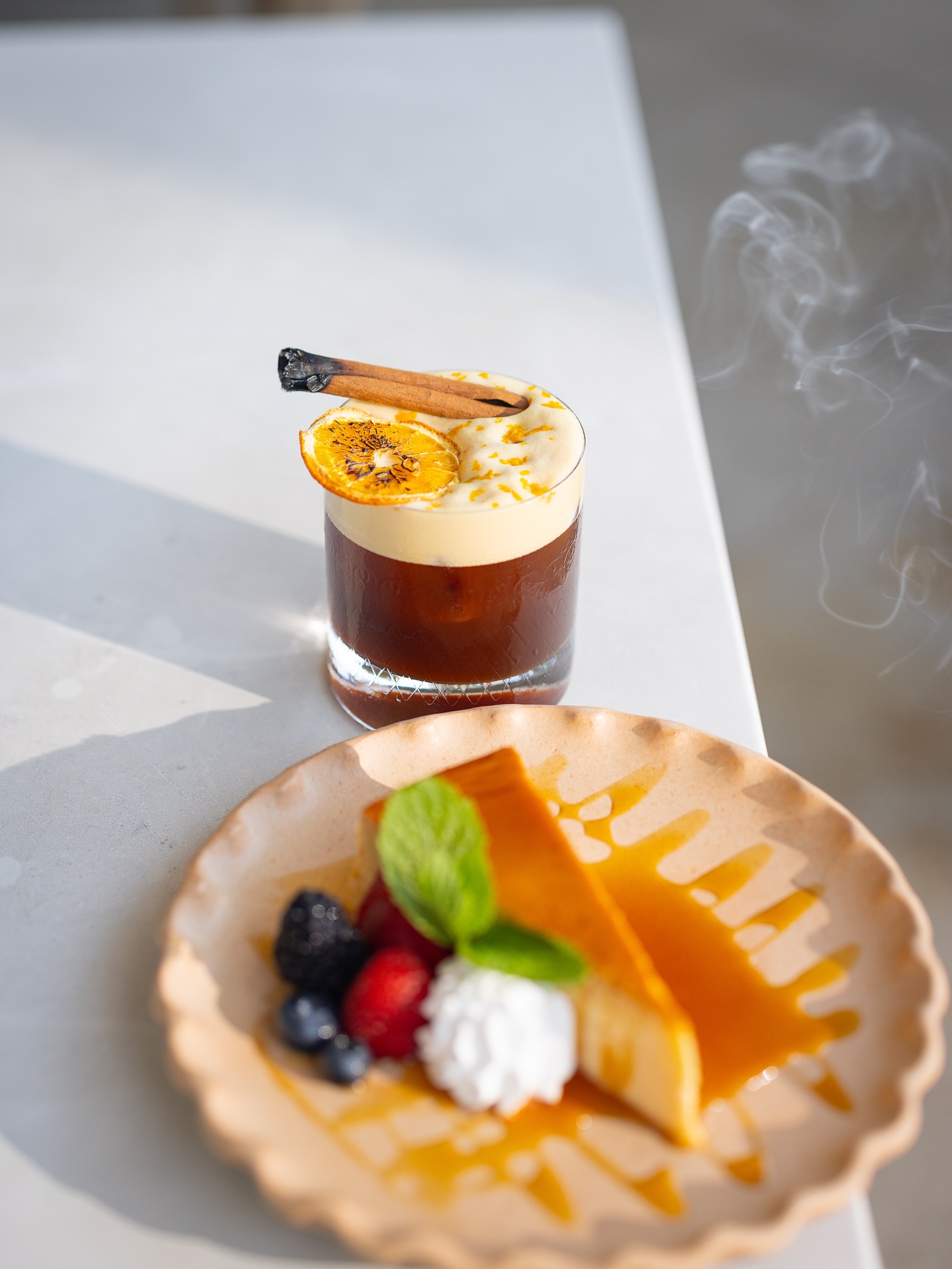 Drink with smoking cinnamon, orange; dessert with caramel, berries, mint.