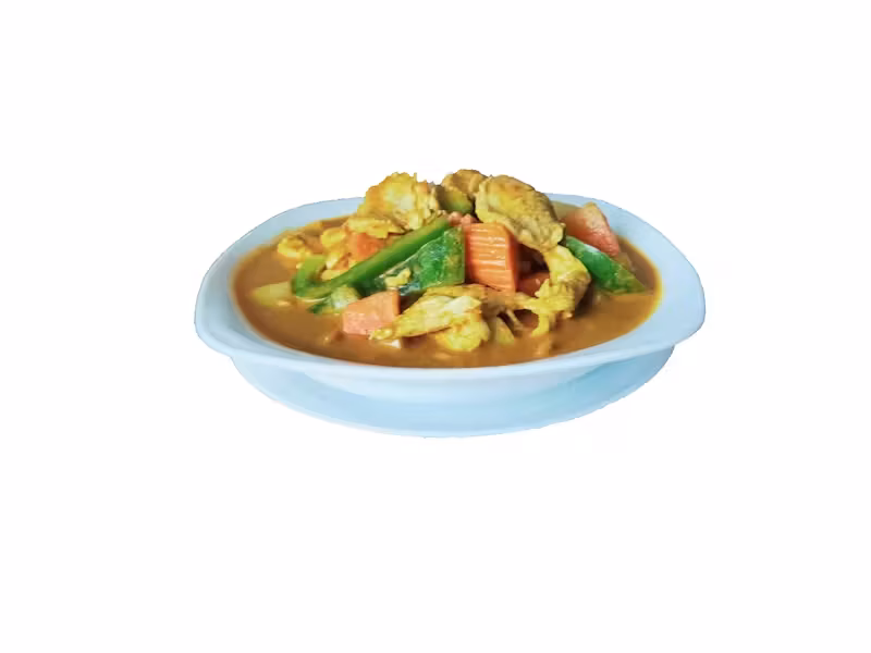 Curry with chicken pieces, green and orange vegetables in a bowl.