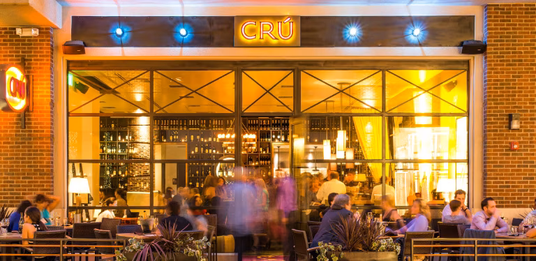 Exterior of CRÚ restaurant with indoor and outdoor dining areas.