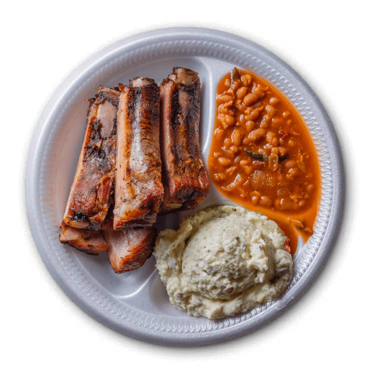 Grilled ribs, baked beans, and potato salad on a white plate.