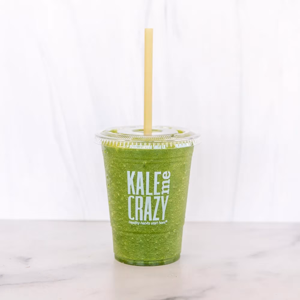 Green smoothie in clear cup with 'KALE me CRAZY' logo.