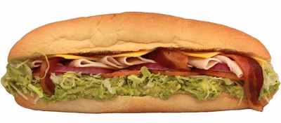 Submarine sandwich with turkey, bacon, cheese, lettuce, onion, and guacamole.
