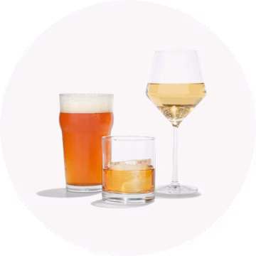 Three glasses: beer, whiskey on the rocks, and white wine.