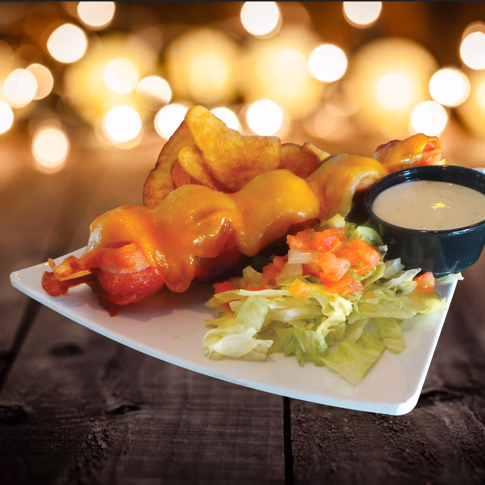 Cheesy bacon skewers, potato wedges, side salad, and dipping sauce.