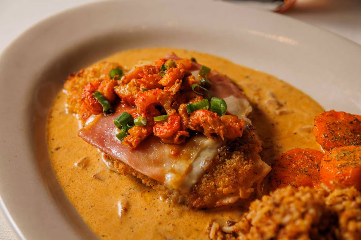 Breaded cutlet with crawfish, ham, cheese, and creamy sauce.