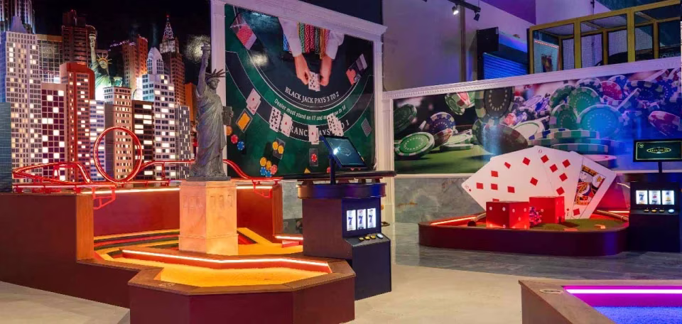 Indoor mini golf course with New York skyline and casino decor.