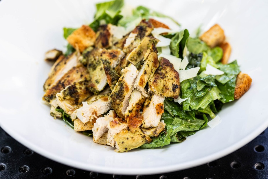 Sliced grilled chicken, lettuce, croutons, and shaved cheese.