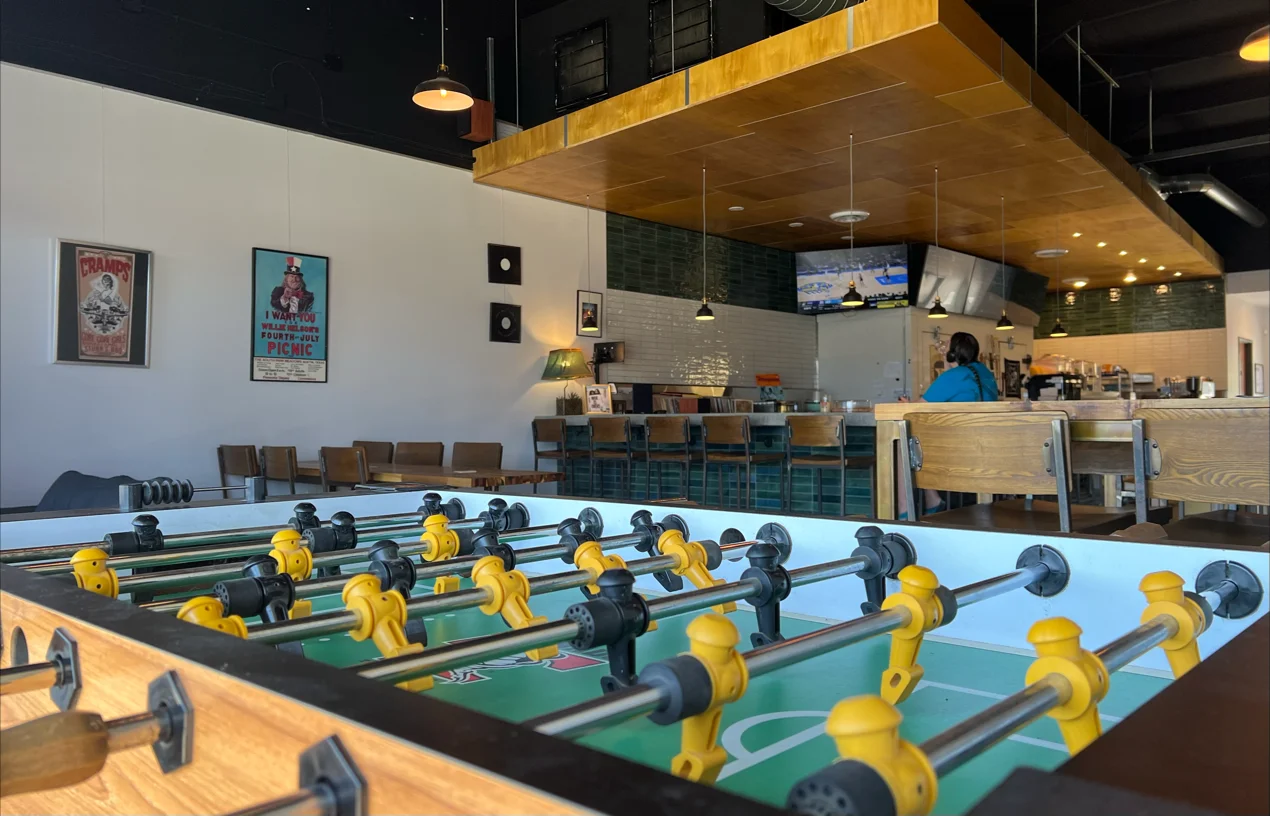 A foosball table in a casual bar or restaurant interior.