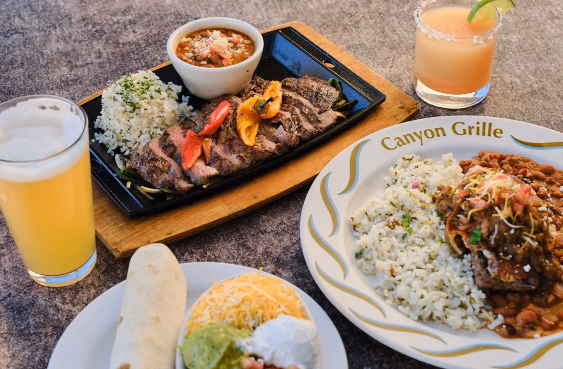 Grilled steak, rice, beans, a burrito, beer, and a margarita.