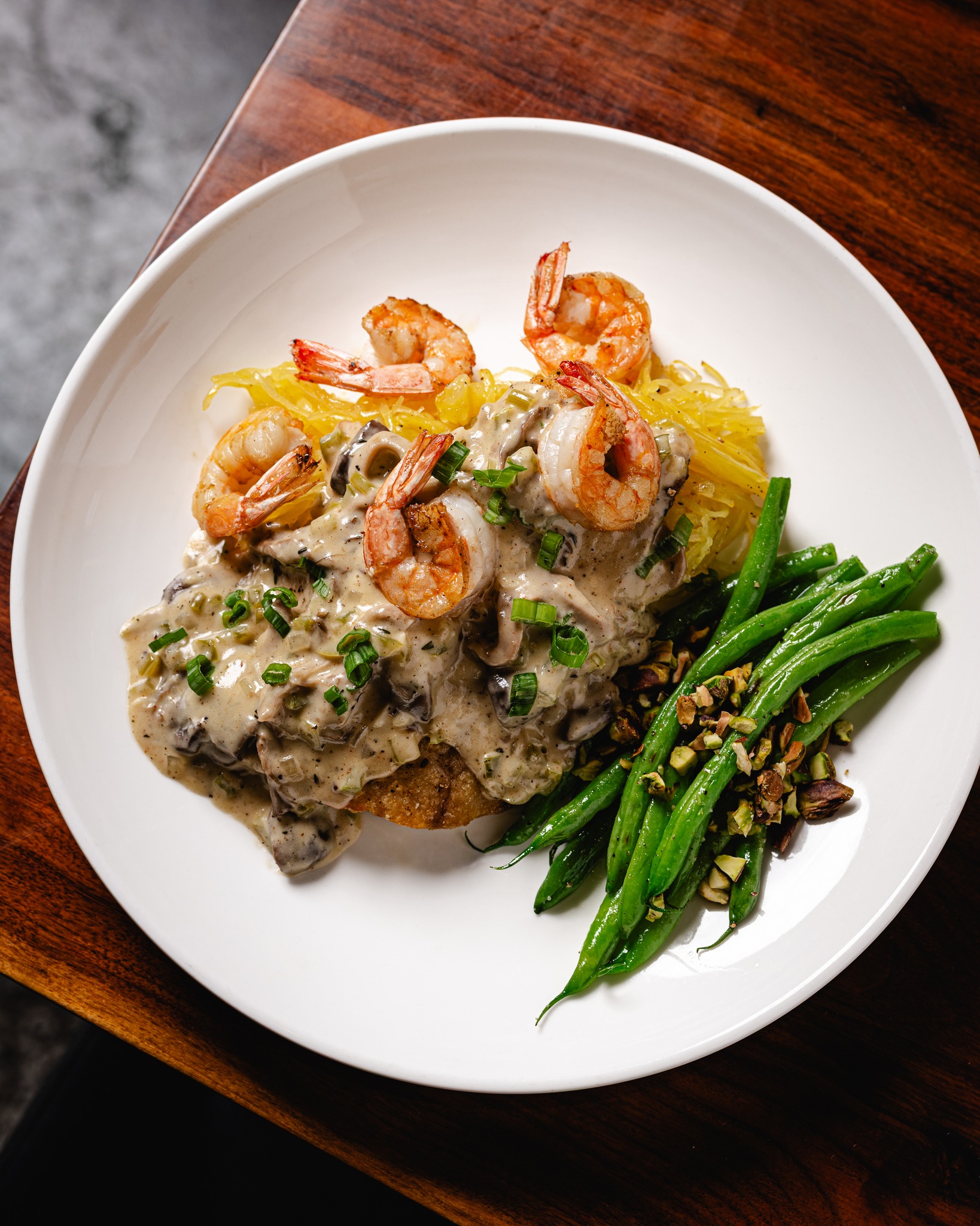 Chicken with creamy mushroom sauce, shrimp, green beans, and spaghetti squash.