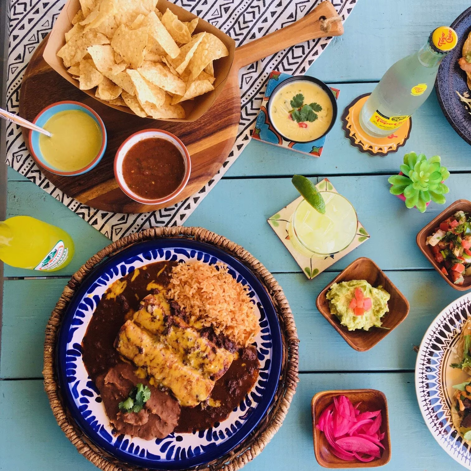 Mexican food spread on a blue wooden table.