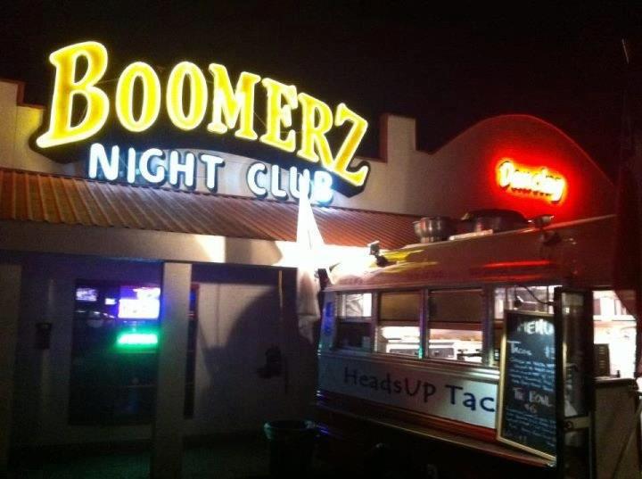 Exterior of Boomerz Night Club and HeadsUP Tacos food truck at night.