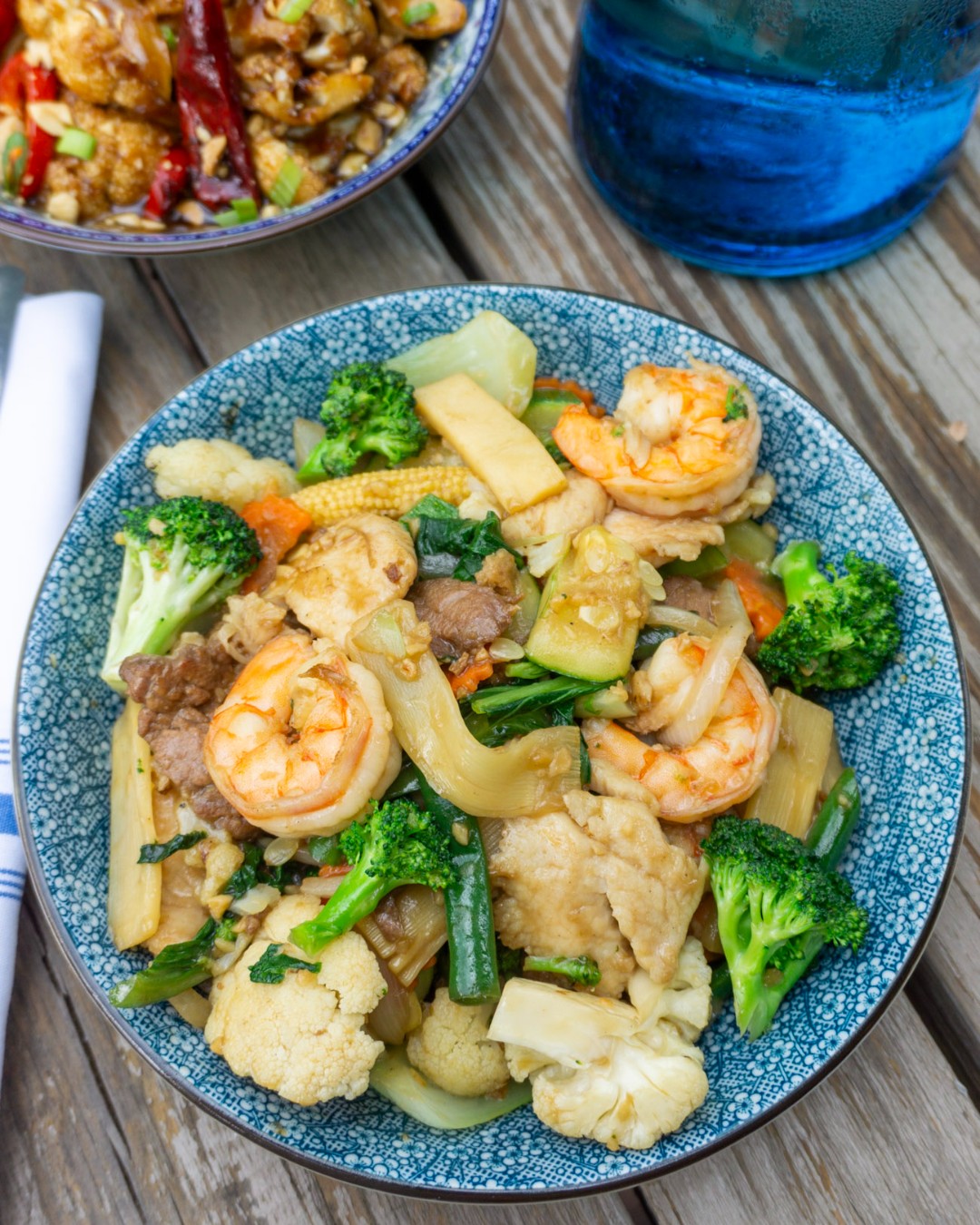 Stir-fry with shrimp, chicken, beef, and mixed vegetables in a bowl.