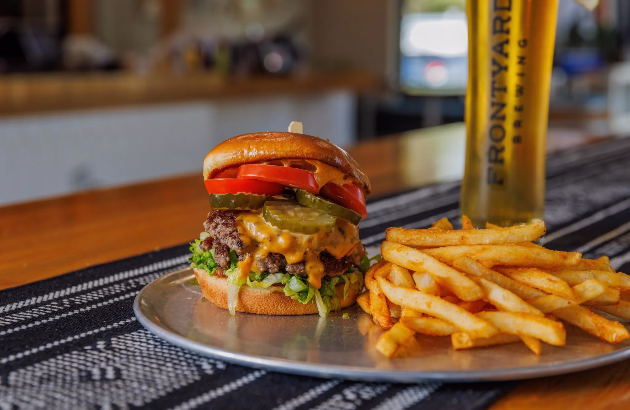 Cheeseburger and french fries with a beer from Frontyard Brewing.