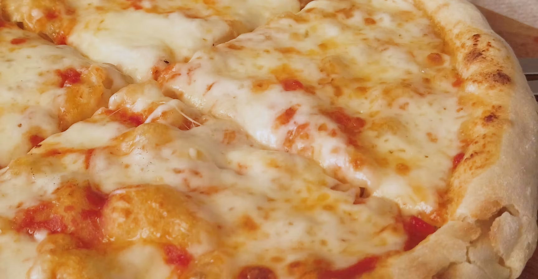 A whole pizza with melted cheese, red sauce, and golden crust.