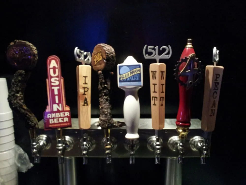 A row of seven distinct beer tap handles.
