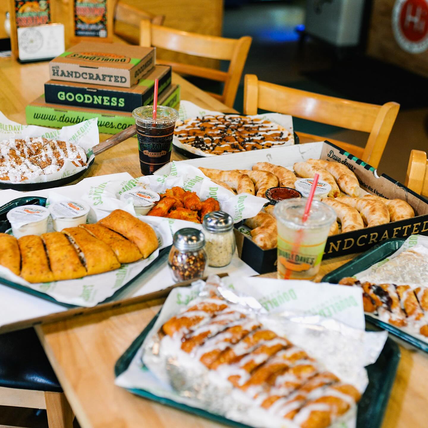Spread of pizza, wings, and desserts from Double Dave's.