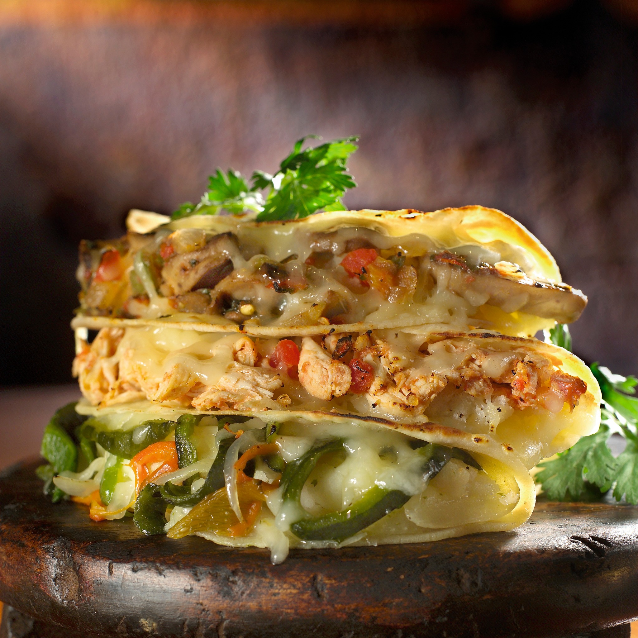 Stacked quesadillas with chicken, mushroom, and poblano pepper fillings.
