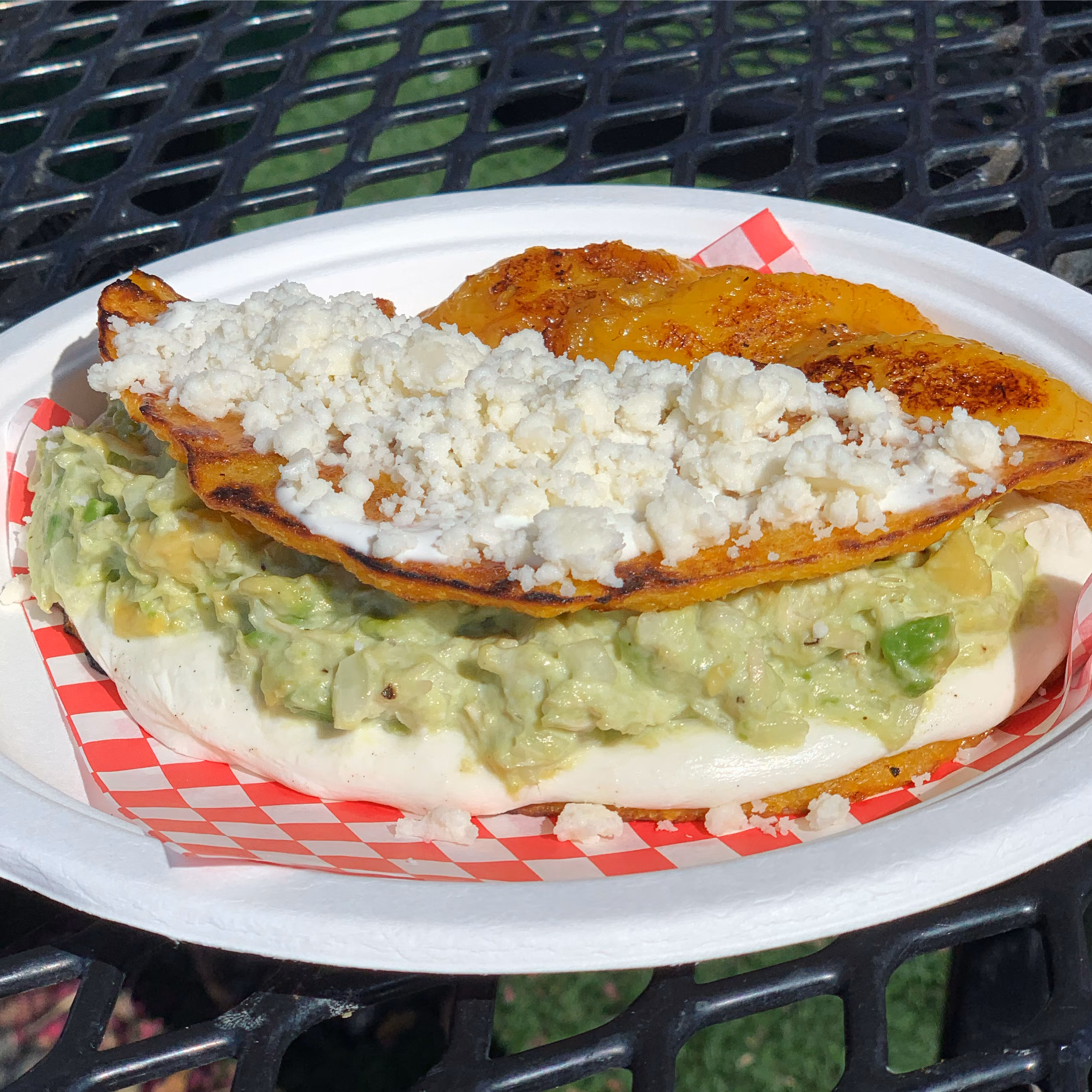 Crispy golden fold with avocado, creamy white filling, and crumbled cheese.