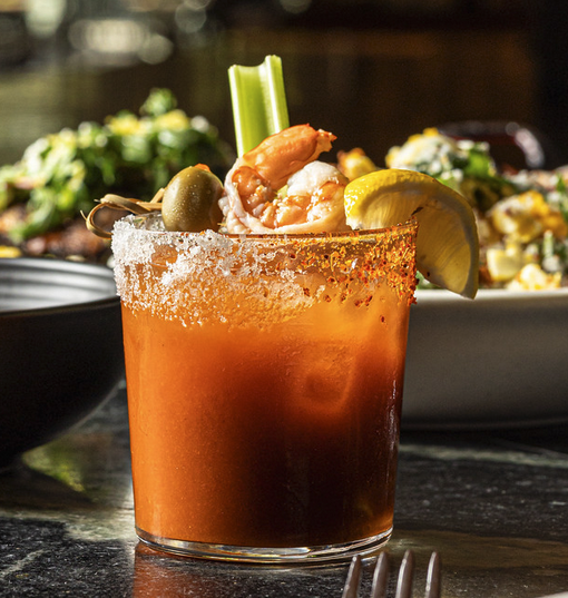 Bloody Mary with shrimp, olive, celery, lemon, and chili-salted rim.