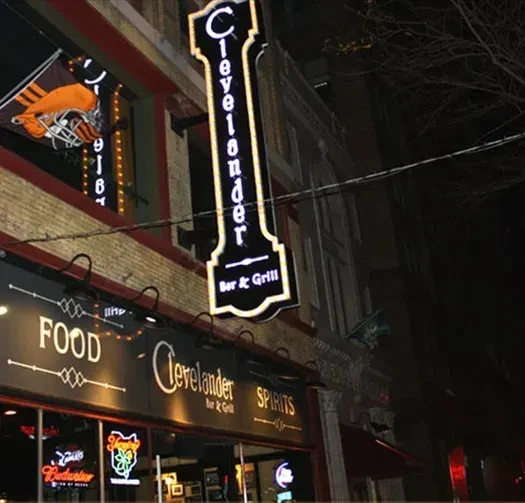 Illuminated Clevelander Bar & Grill building at night with Browns banner.
