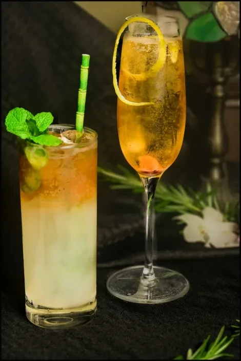 Two vibrant cocktails: one layered with mint, one sparkling with lemon.